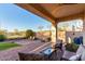 Relaxing covered patio with desert landscaping and outdoor seating area offers serene views of the natural surroundings at 9286 W Buckhorn Trl, Peoria, AZ 85383