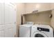 Convenient laundry room with modern washer and dryer and extra storage shelves at 9286 W Buckhorn Trl, Peoria, AZ 85383