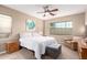 Serene main bedroom with soft lighting, carpet flooring, and a seating area by the window at 9286 W Buckhorn Trl, Peoria, AZ 85383