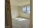 A bedroom with two windows is under construction at 9614 W Parkway Dr, Tolleson, AZ 85353