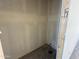 A closet features white walls and concrete floor at 9614 W Parkway Dr, Tolleson, AZ 85353