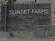 Street view of the Sunset Farms community entrance sign surrounded by desert landscaping at 9614 W Parkway Dr, Tolleson, AZ 85353