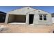 A single story home under construction showcases a beige color and an open two-car garage at 9614 W Parkway Dr, Tolleson, AZ 85353