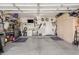 Organized garage featuring storage cabinets and work area at 9857 E Fairview Ave, Mesa, AZ 85208