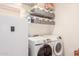 Bright laundry room with washer, dryer and storage at 9857 E Fairview Ave, Mesa, AZ 85208