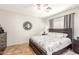 Bedroom features a ceiling fan, mirror, and dark wood furnishings at 9857 E Fairview Ave, Mesa, AZ 85208