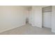 A secondary bedroom with light carpet and double door closet at 9939 W Southgate Ave, Tolleson, AZ 85353