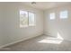 Bright bedroom featuring neutral carpet, natural light from three windows, and a clean, minimalist aesthetic at 9939 W Southgate Ave, Tolleson, AZ 85353