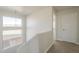 A bright upstairs hallway with natural light, white walls, and carpet flooring at 9939 W Southgate Ave, Tolleson, AZ 85353