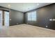 Upstairs bedroom featuring neutral carpet and gray walls at 10013 E Trent Ave, Mesa, AZ 85212