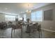 Bright dining room with modern table, chairs, and ample natural light at 10013 E Trent Ave, Mesa, AZ 85212