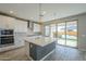 Modern kitchen with an island, stainless steel appliances, and sliding glass doors at 10013 E Trent Ave, Mesa, AZ 85212