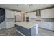 Bright, modern kitchen with white cabinets, an island, stainless steel appliances at 10013 E Trent Ave, Mesa, AZ 85212