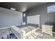 Elegant main bedroom with gray walls, carpeted floor, and white headboard bed frame at 10013 E Trent Ave, Mesa, AZ 85212