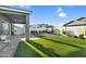 An expansive artificial lawn area is framed by lush landscaping and a block wall for privacy at 10144 E Thistle Ave, Mesa, AZ 85212