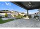 Relax and enjoy the covered patio, pavers, outdoor furniture and green space in this backyard at 10144 E Thistle Ave, Mesa, AZ 85212