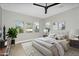 Staged bedroom with luxury bedding and natural light from the windows, creating a cozy and peaceful retreat at 10144 E Thistle Ave, Mesa, AZ 85212