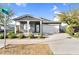 Charming single-story home with a well-manicured lawn, inviting covered porch, and two-car garage at 10144 E Thistle Ave, Mesa, AZ 85212