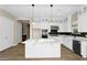 Bright kitchen featuring white cabinetry, a spacious island, and modern stainless steel appliances at 10144 E Thistle Ave, Mesa, AZ 85212