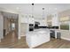 Modern kitchen with white cabinets, a center island, stainless steel appliances, and stylish backsplash at 10144 E Thistle Ave, Mesa, AZ 85212