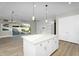 Kitchen island with pendant lights, connecting the indoor living space to the outdoors at 10144 E Thistle Ave, Mesa, AZ 85212