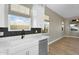 Kitchen sink area with a view outside, featuring white cabinets and modern hardware at 10144 E Thistle Ave, Mesa, AZ 85212