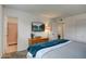 Bright main bedroom featuring a flatscreen TV and an attached bathroom with pink tile at 1015 E Concorda Dr, Tempe, AZ 85282