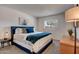 Cozy main bedroom with soft carpet, a bright window, and an inviting blue-toned bed at 1015 E Concorda Dr, Tempe, AZ 85282