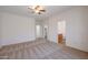 Bedroom with neutral carpet, ceiling fan, and access to a bathroom and walk-in closet at 11725 W Jefferson St, Avondale, AZ 85323