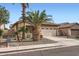 Attractive home with lush palm trees, gravel landscaping, and a convenient two-car garage at 11725 W Jefferson St, Avondale, AZ 85323