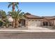 Charming single-story home featuring mature palm trees and a well-maintained desert landscape at 11725 W Jefferson St, Avondale, AZ 85323