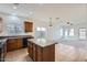 Bright kitchen with granite countertops and center island with views to the living area at 11725 W Jefferson St, Avondale, AZ 85323