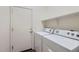 Laundry room with shelving, a utility sink, and full-size washer and dryer at 11725 W Jefferson St, Avondale, AZ 85323