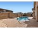 Backyard view of private pool surrounded by a brick wall and nearby landscaping at 11725 W Jefferson St, Avondale, AZ 85323