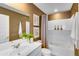 Well-lit bathroom with a sleek vanity, decorative mirror, a tub with shower, and a stylish accent wall at 11959 E Primrose Ln, Florence, AZ 85132