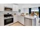 Modern kitchen featuring stainless steel appliances, white cabinets, and a quartz countertop with a sink at 11959 E Primrose Ln, Florence, AZ 85132