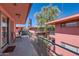 Spacious balcony with a view of the building's exterior and surrounding palm trees at 126 E Coronado Rd # 39, Phoenix, AZ 85004