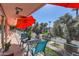 Relaxing balcony with an umbrella offering shade, surrounded by lush trees and neighborhood views at 146 E Coronado Rd # 39, Phoenix, AZ 85004