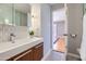 Bright bathroom featuring a floating vanity, stylish mirror and decorative mosaic backsplash at 146 E Coronado Rd # 39, Phoenix, AZ 85004