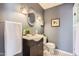 Charming bathroom featuring a vanity, decorative mirror, and tiled floor at 146 E Coronado Rd # 39, Phoenix, AZ 85004