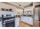 Well-lit kitchen featuring stainless steel appliances, white cabinets, and a beautiful marble countertop at 126 E Coronado Rd # 39, Phoenix, AZ 85004