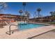 Inviting outdoor pool surrounded by palm trees and lounge chairs, perfect for relaxation and recreation at 126 E Coronado Rd # 39, Phoenix, AZ 85004