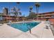 Refreshing community pool with comfortable lounge chairs, enhanced by tropical palm trees and sunny skies at 146 E Coronado Rd # 39, Phoenix, AZ 85004