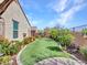 Backyard of a one story home with a well-manicured artificial lawn and desert landscaping at 13451 W Remuda Dr, Peoria, AZ 85383