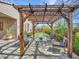 Relax in this inviting backyard featuring a pergola, comfortable seating, and lush landscaping at 13451 W Remuda Dr, Peoria, AZ 85383