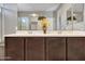 Modern bathroom featuring a double vanity with dark cabinets, quartz counters and neutral wall paint at 13451 W Remuda Dr, Peoria, AZ 85383