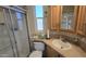 A cozy bathroom features a glass door shower, a wood cabinet, and a tile countertop at 17200 W Bell Rd # 299, Surprise, AZ 85374