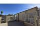 Charming home featuring a separate storage unit and well-maintained exterior with sliding door access at 17200 W Bell Rd # 299, Surprise, AZ 85374