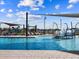 Community swimming pool with splash pad, sunshades, and comfortable lounge chairs at 17702 W Amber Dr, Goodyear, AZ 85338