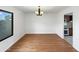 Bright dining room with wood floors, a modern chandelier, and a window with a view at 1810 W Kiowa Cir, Mesa, AZ 85202